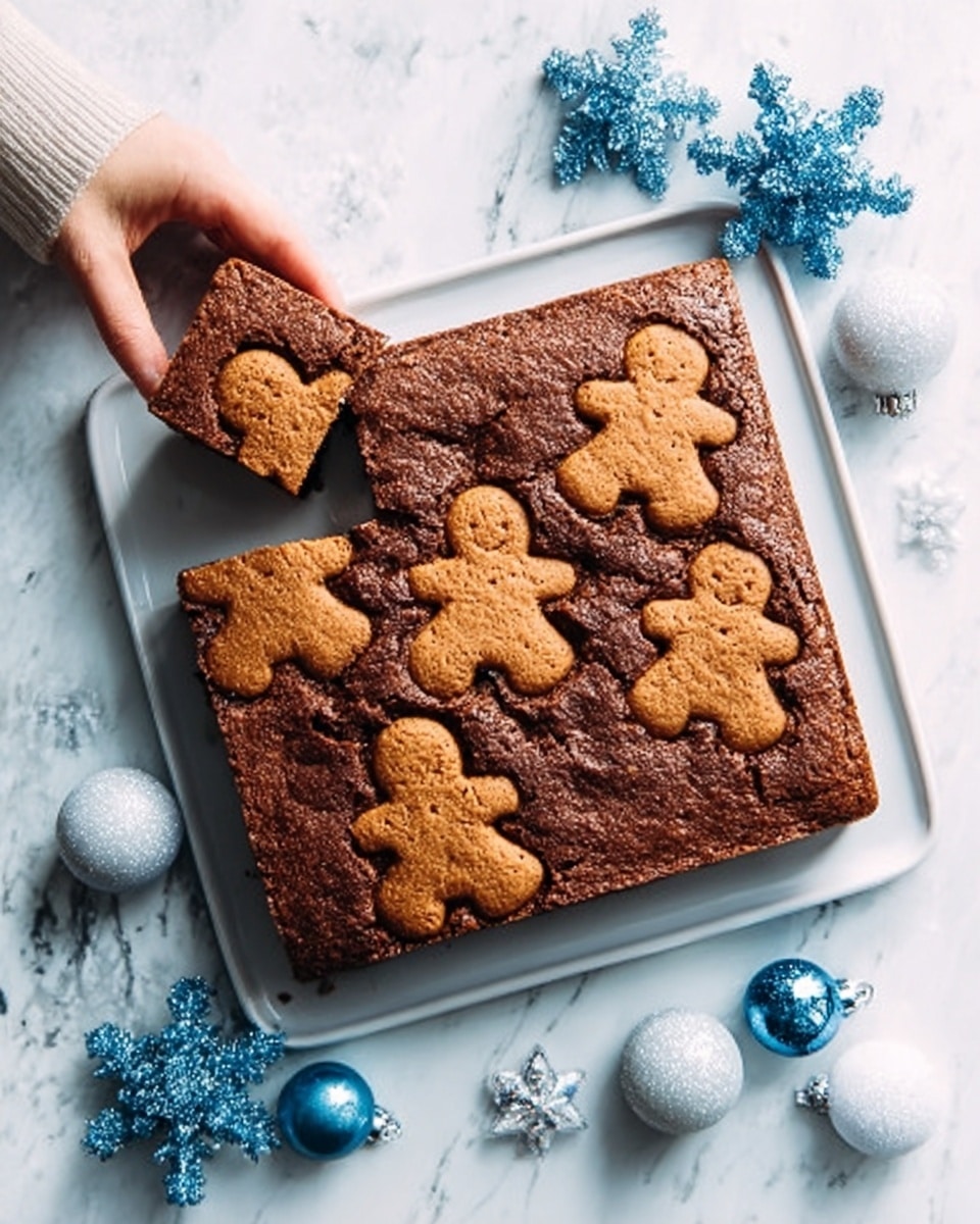 A white square cake with a smooth brown top is decorated with gingerbread cookie shapes pressed into it, showing different sizes of gingerbread men and stars all over the surface. Two pieces are cut out from the top right corner and are slightly pulled out. The cake sits on a white marbled surface with a silver knife beside it. Around the cake, there are small blue and white Christmas ornaments. Photo taken with an iphone --ar 4:5 --v 7