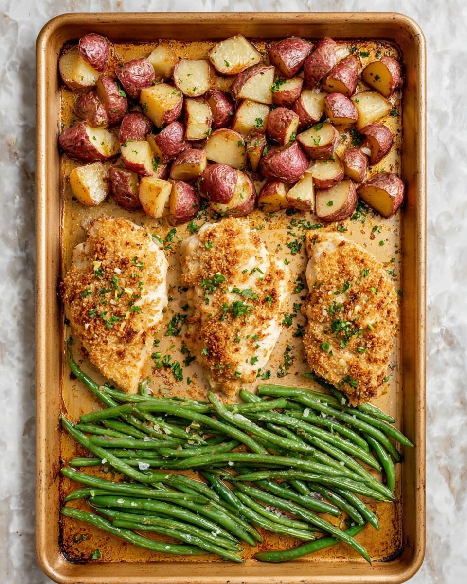 A gold baking tray filled with a meal showing three large pieces of baked chicken in the center with a crispy, golden top sprinkled with small green herbs. Above the chicken pieces, there is a layer of small, chunky roasted red potatoes with a browned, slightly crispy texture and bits of green herbs sprinkled across. Below the chicken, there is a layer of cooked green beans arranged neatly, with a shiny, tender look. The tray is placed on a white marbled surface. photo taken with an iphone --ar 4:5 --v 7