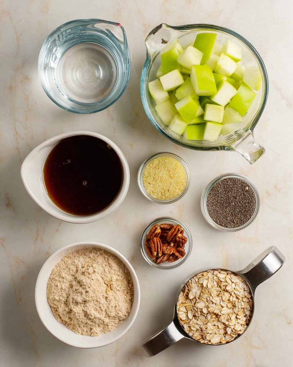 The image shows a top view of ingredients arranged neatly on a white marbled surface. There are seven small containers or bowls, each holding different items: one holds clear water in a glass measuring cup, one contains cubed green apple pieces in a metal measuring cup, one white bowl has a thick dark brown syrup, another small glass jar is filled with black chia seeds, next is a glass bowl of light yellow almond flour, another white bowl has a pile of ground cinnamon, and one small glass jar holds pecan halves. Lastly, a metal measuring cup is filled with rolled oats, showing their light beige color and flaky texture. The layout is simple, clean, and organized. photo taken with an iphone --ar 4:5 --v 7