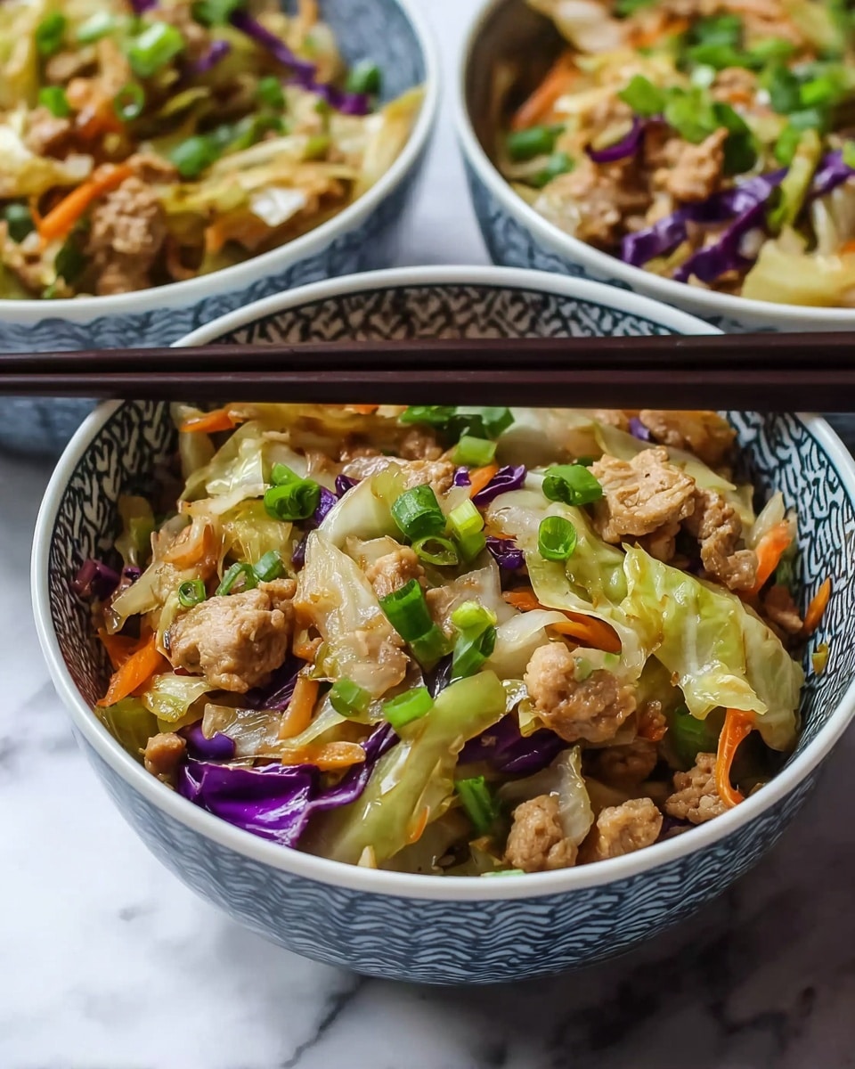 The image shows three white bowls filled with a stir-fry dish. Each bowl has chopped pieces of light brown cooked meat layered with pale green cooked cabbage, thin strips of orange carrots, and small bits of purple cabbage mixed in. The dish is topped with bright green chopped scallions. One bowl in the front is held by a pair of dark wooden chopsticks resting on its edge. The bowls have a blue pattern on the outside, and they sit on a white marbled surface. The colors are vibrant and the textures look tender and moist photo taken with an iphone --ar 4:5 --v 7