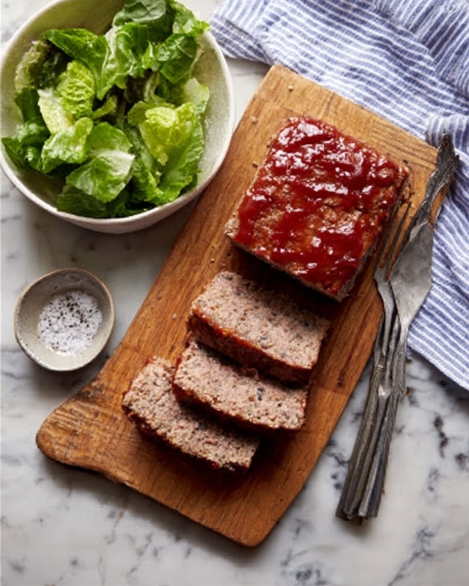 A wooden board on a white marbled surface holds a meatloaf and three slices placed next to it. The meatloaf has a slightly browned, glazed top with a reddish sauce. To the left of the board, there is a white bowl filled with mixed green lettuce leaves. Below the meatloaf slices, a small white bowl contains coarse salt or pepper. A woman's hand is holding a long metal fork above the board. A blue and white striped cloth is partially visible on the top right corner of the board. Photo taken with an iphone --ar 4:5 --v 7