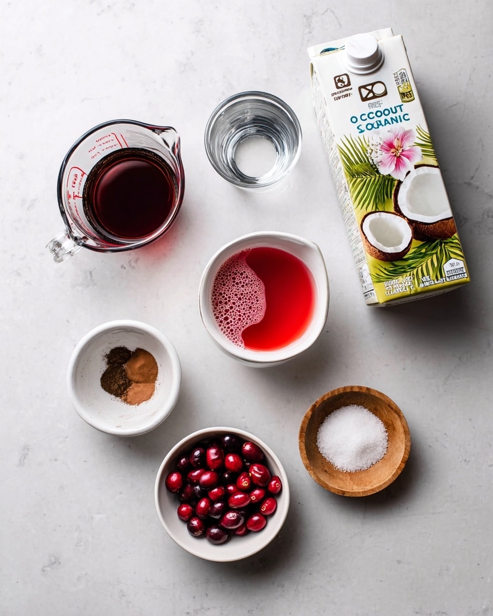 A flat lay of ingredients on a white marbled surface includes a tall carton of vanilla organic coconut milk standing on the top right, showing a green leaf, a coconut half, and a vanilla flower on its label. To its left, there is a clear glass measuring cup filled with dark red liquid, and below it another clear measuring cup with transparent liquid. Below the milk carton, a small white bowl holds bright red liquid with a foam bubble in the center. On the bottom left, a white bowl contains two brown spices side by side. To the right of that, a white bowl filled with halved fresh cranberries showing their red pulp. Finally, on the bottom right, a small wooden bowl contains a small amount of white coarse salt. Photo taken with an iphone --ar 4:5 --v 7